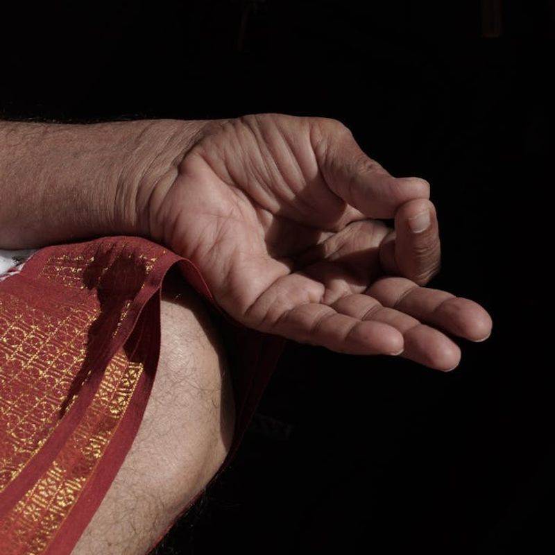 Close up of hands in a mudra position.