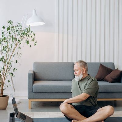 Minimalist yoga room with wooden floor.